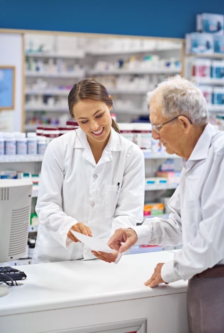 GLP-1 treatment in Ireland, explained Two pharmacists checking a prescription at a pharmacy counter